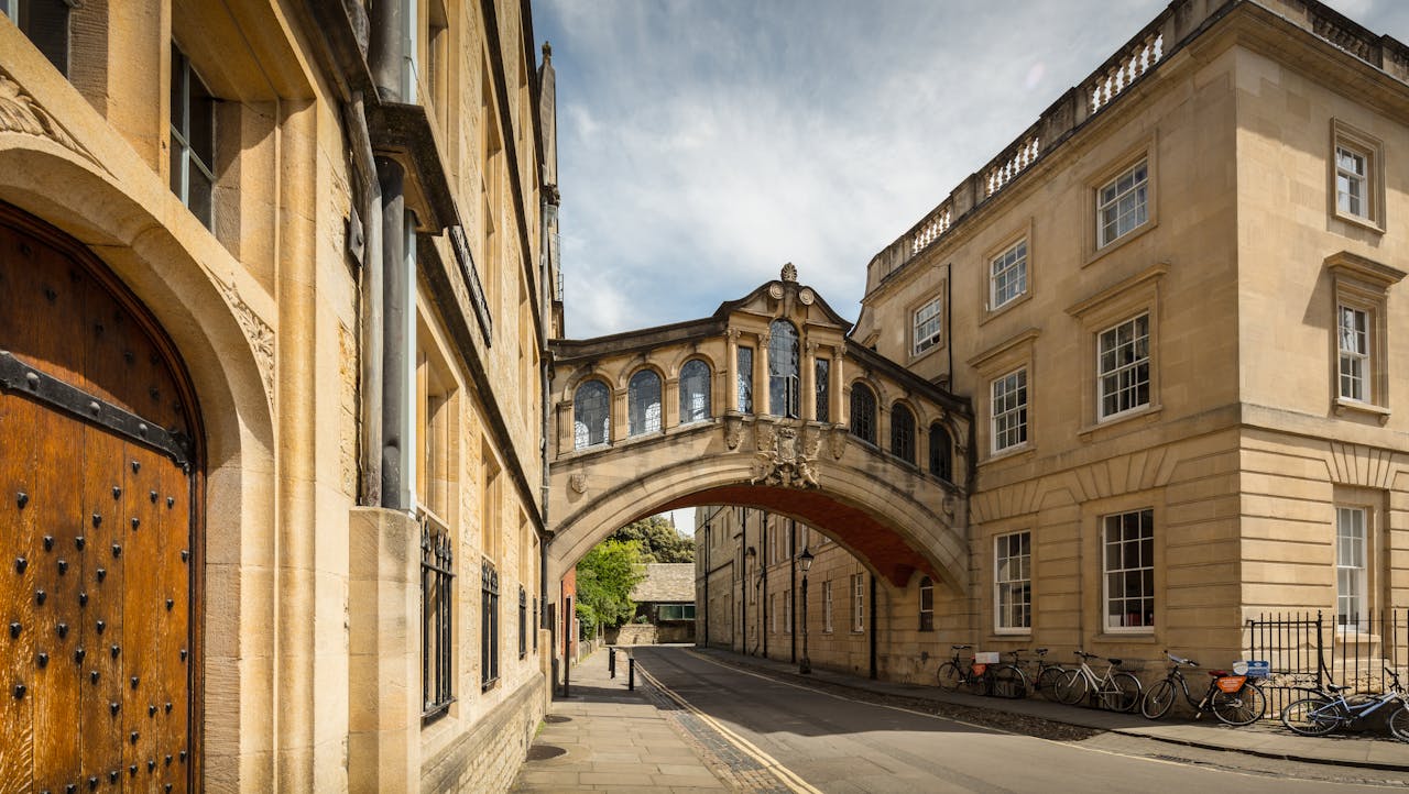 A split image showing a historic British private school on one side and a modern American public school on the other, illustrating the term “public school” differences.