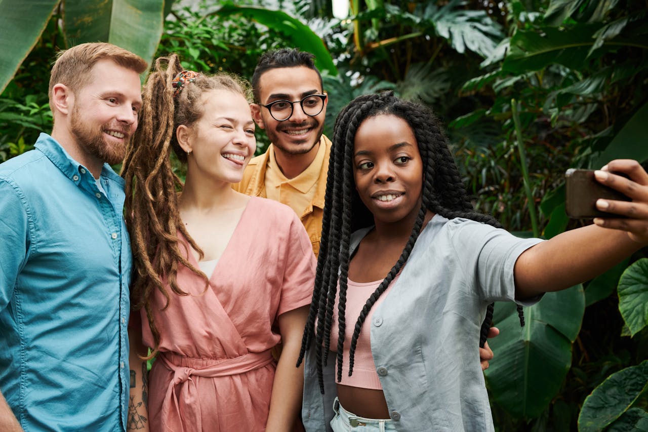 Friends enjoying a concert outdoors, smiling and taking photos together