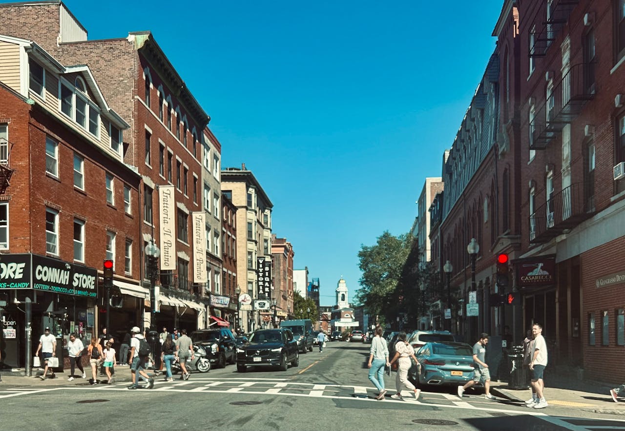 People talking on a Boston street near historic buildings