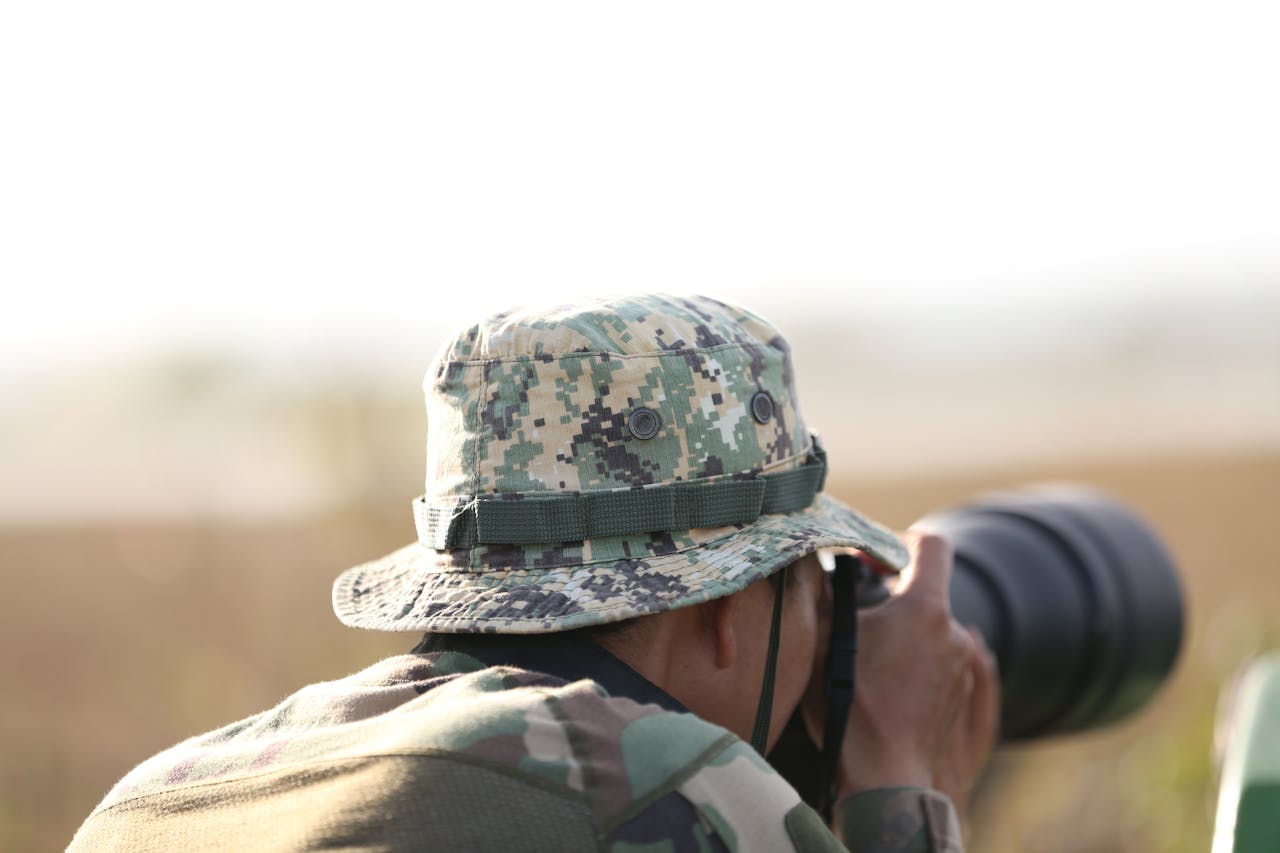 Person silently observing wildlife from a distance without speaking