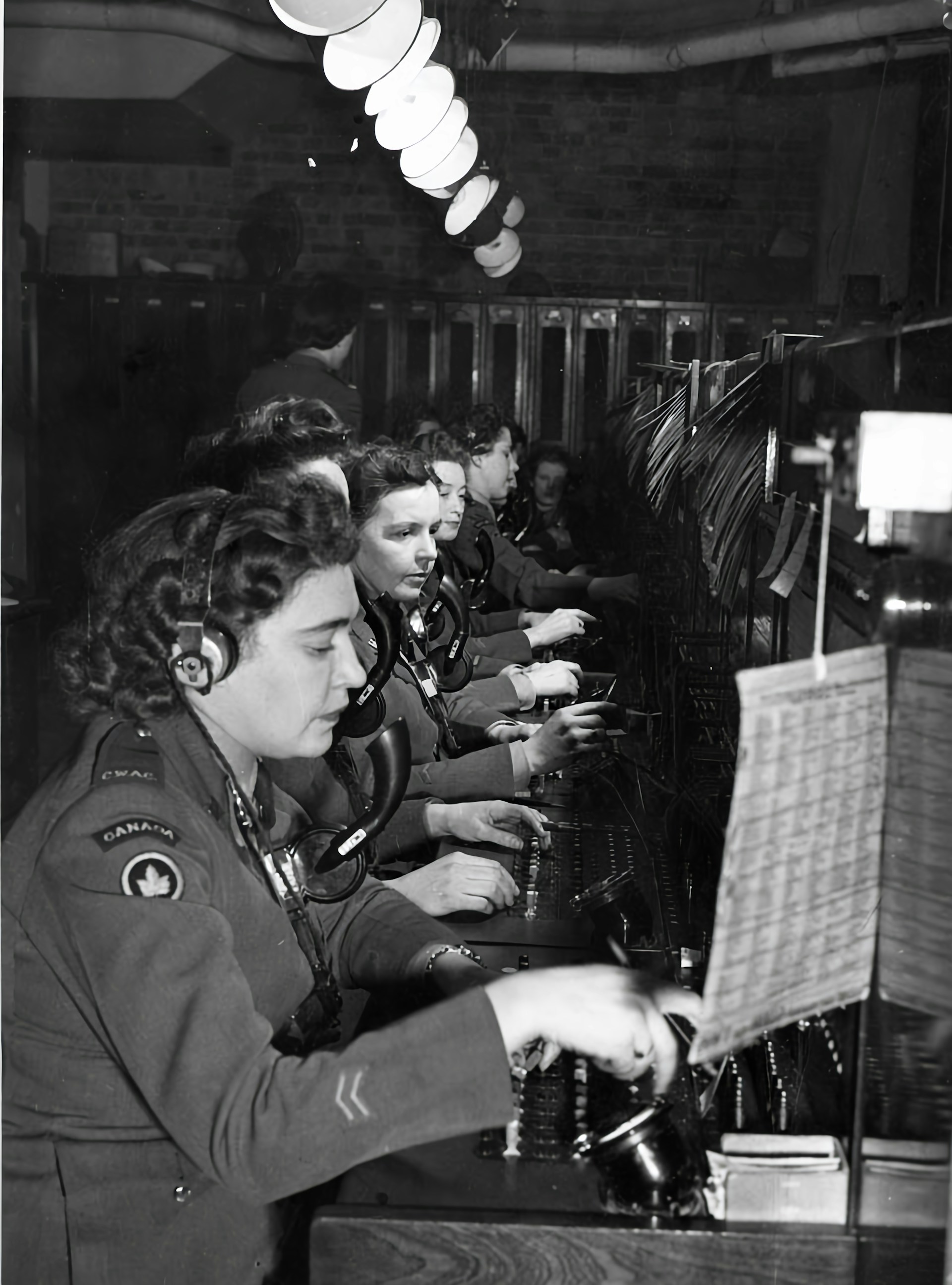 Group of female switchboard operators in military uniforms at work in France during World War I