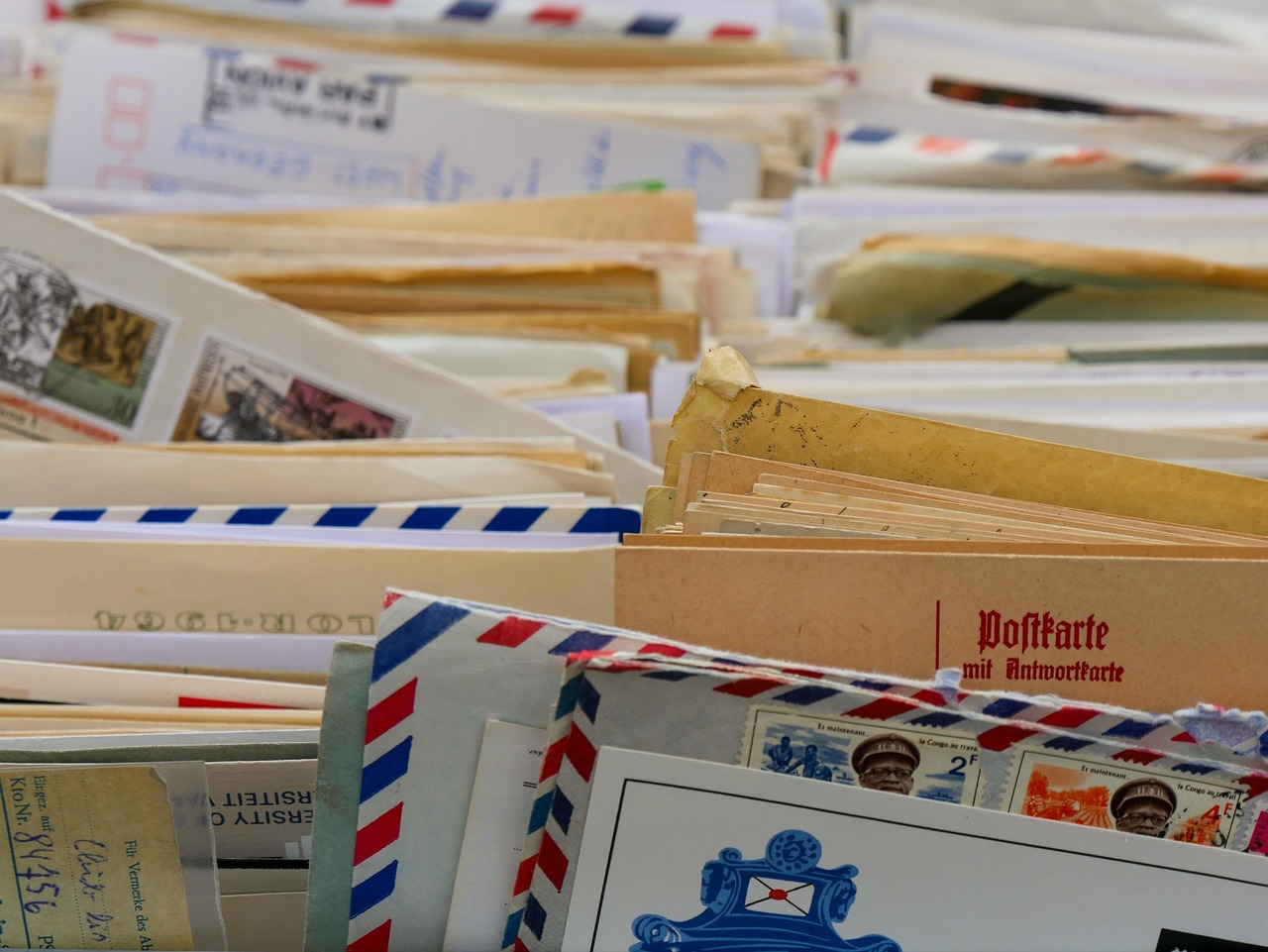 Rows of mailboxes or postal bins filled with envelopes inside a mail sorting facility.