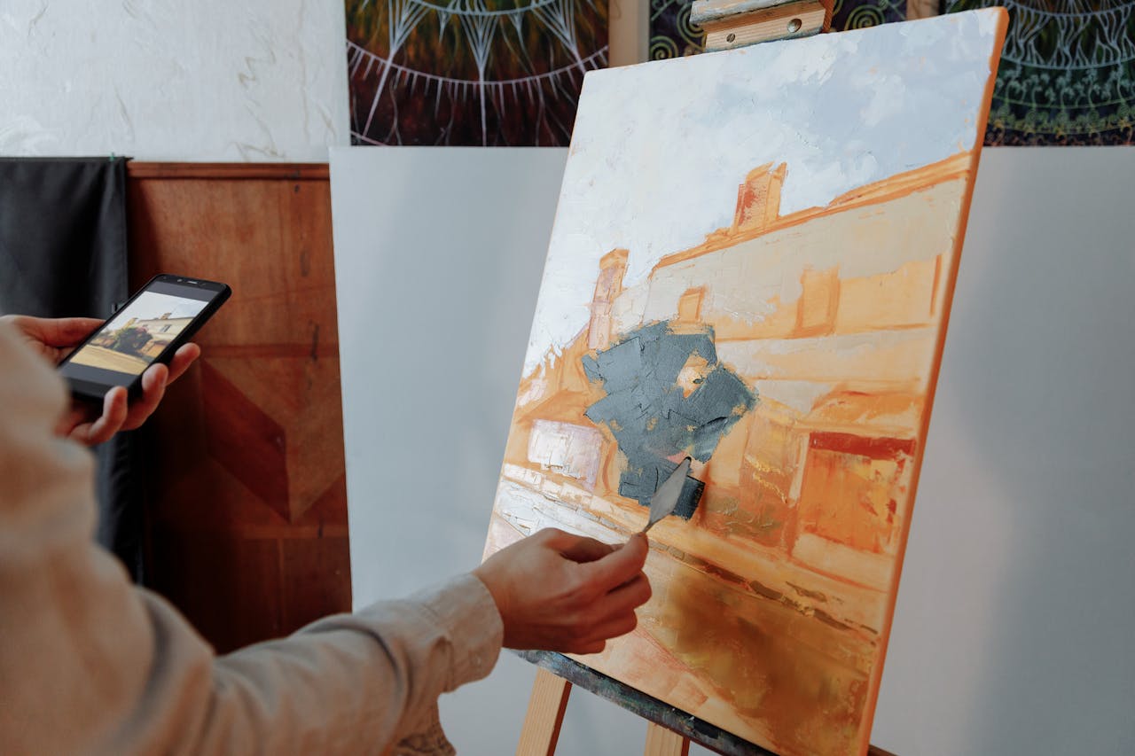 Norman Rockwell painting himself at an easel with reference photos nearby, reflecting artistic process