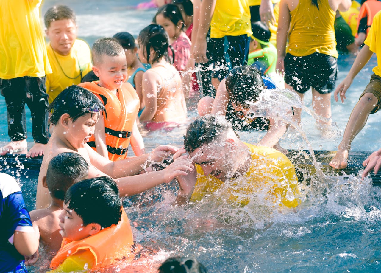 Children playing in a backyard pool under supervision, showing summer energy and leisure
