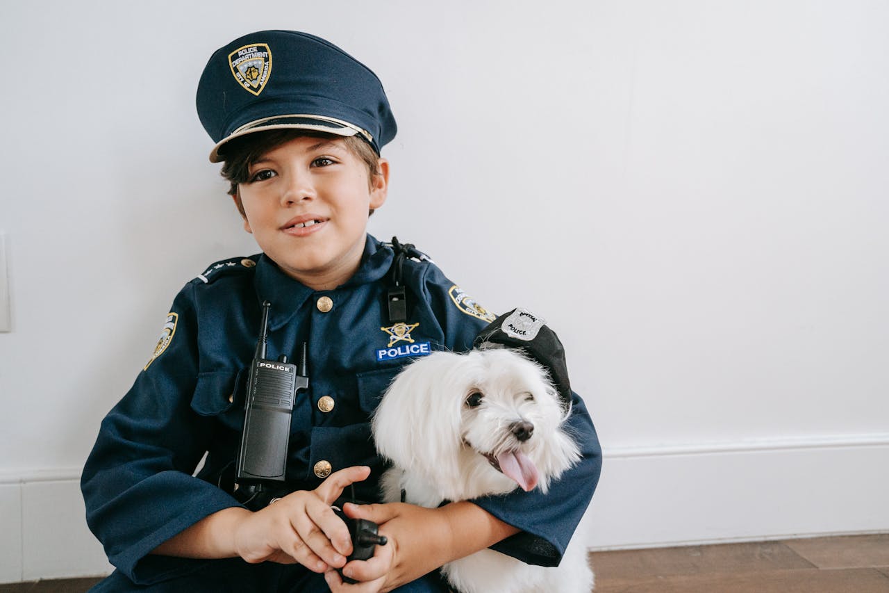 Young boy playing with a dog indoors, both showing playful expressions