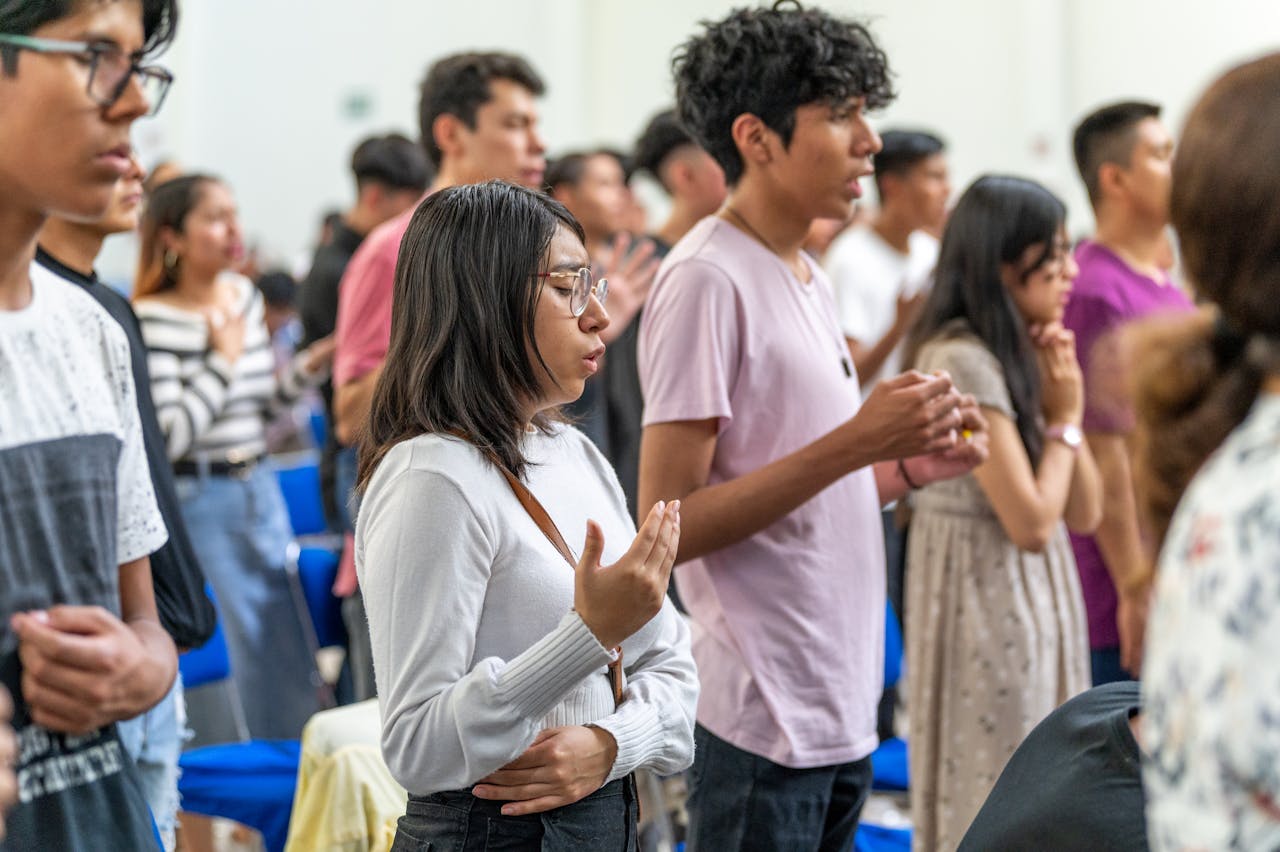 Diverse congregation praying in a church, showing reverence and quiet reflection