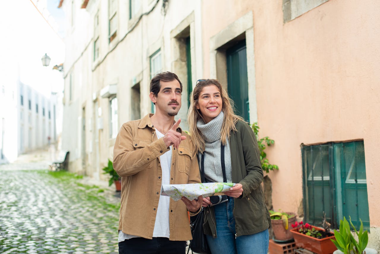 Travelers at landmark with city pass, showing that strategic planning can make attractions affordable.