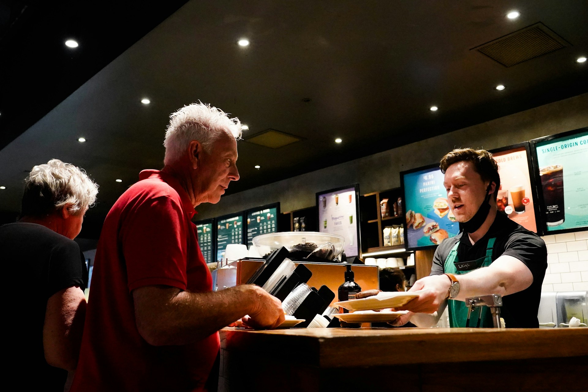 Traveler tipping local server at café, demonstrating tipping customs vary by region and culture.