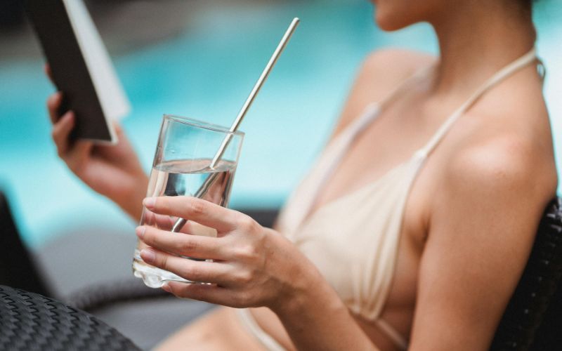 Tourist paying for pool or water sports rental at resort