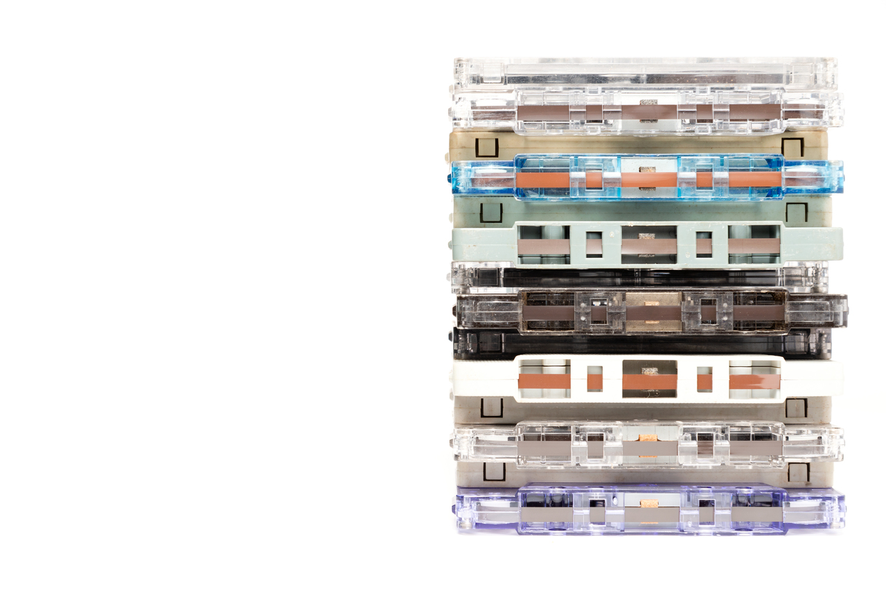 A small stack of cassettes with worn labels and faded handwriting.