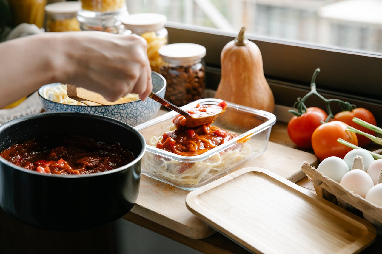 Hotdish ingredients laid out on a kitchen counter, including pasta, canned vegetables, and soup, highlighting easy pantry-friendly cooking.
