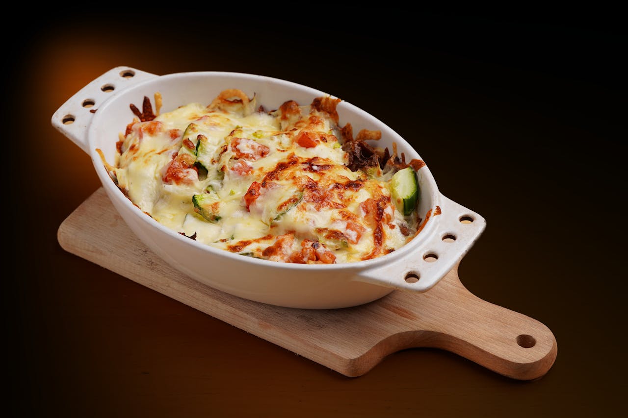 Hotdish casserole served in a dish with melted cheese, tender vegetables, and a golden crust, showcasing a classic comfort meal.