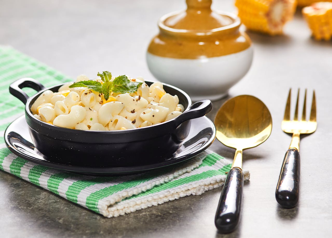Close-up of a cheesy hotdish with a serving taken out, evoking memories of home-cooked meals and Midwestern tradition.