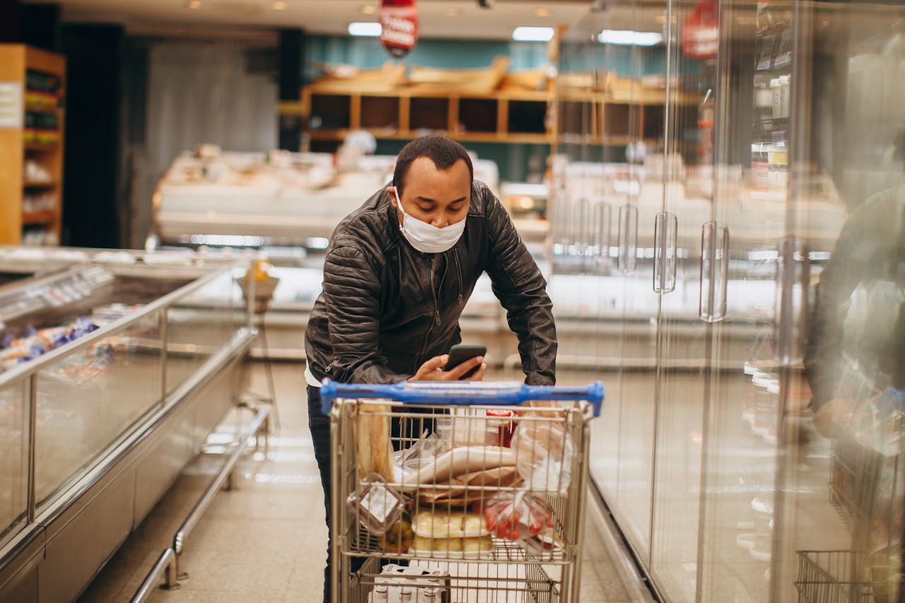 Customer using speakerphone in a supermarket aisle while others shop