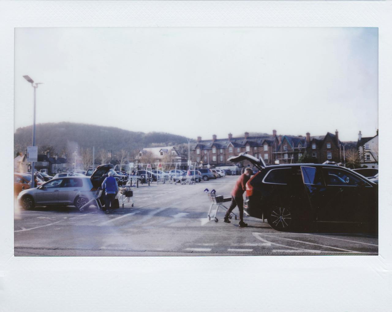 Shopping cart left in a parking lot creating hazards for parked cars