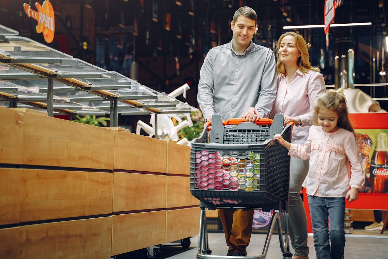 Shoppers navigating a busy American supermarket aisle with carts and groceries.
