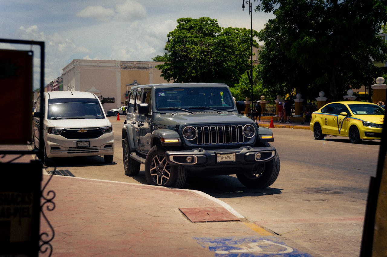 Jeep 4xe parked in a driveway with owner reviewing safety updates and recall notices