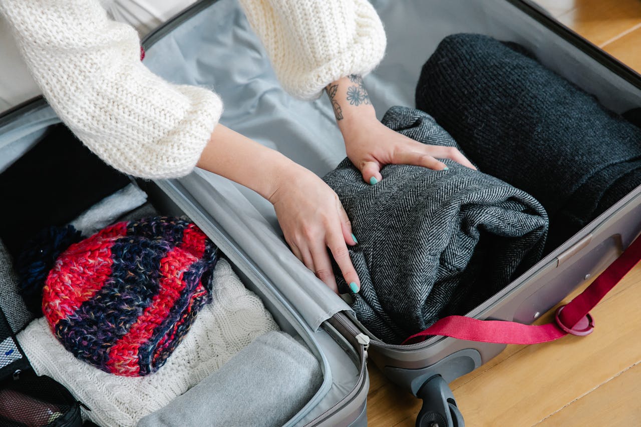 Bulky clothing items compressed in a bag to maximize luggage space efficiently.