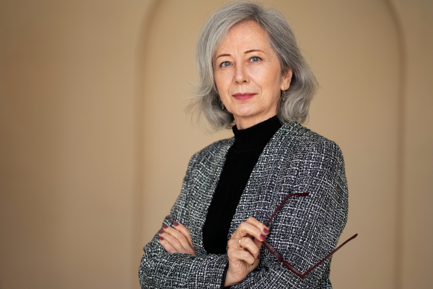 Confident woman in her 60s wearing a modern blazer and jeans