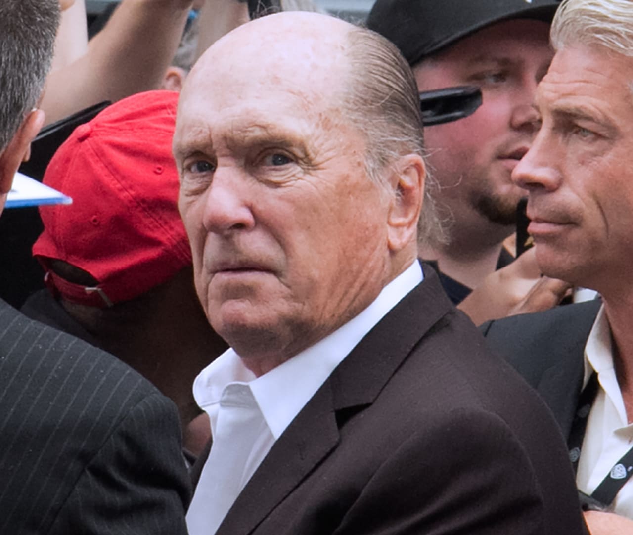 Robert Duvall as Tom Hagen in a composed, suited moment that captures his calm authority.