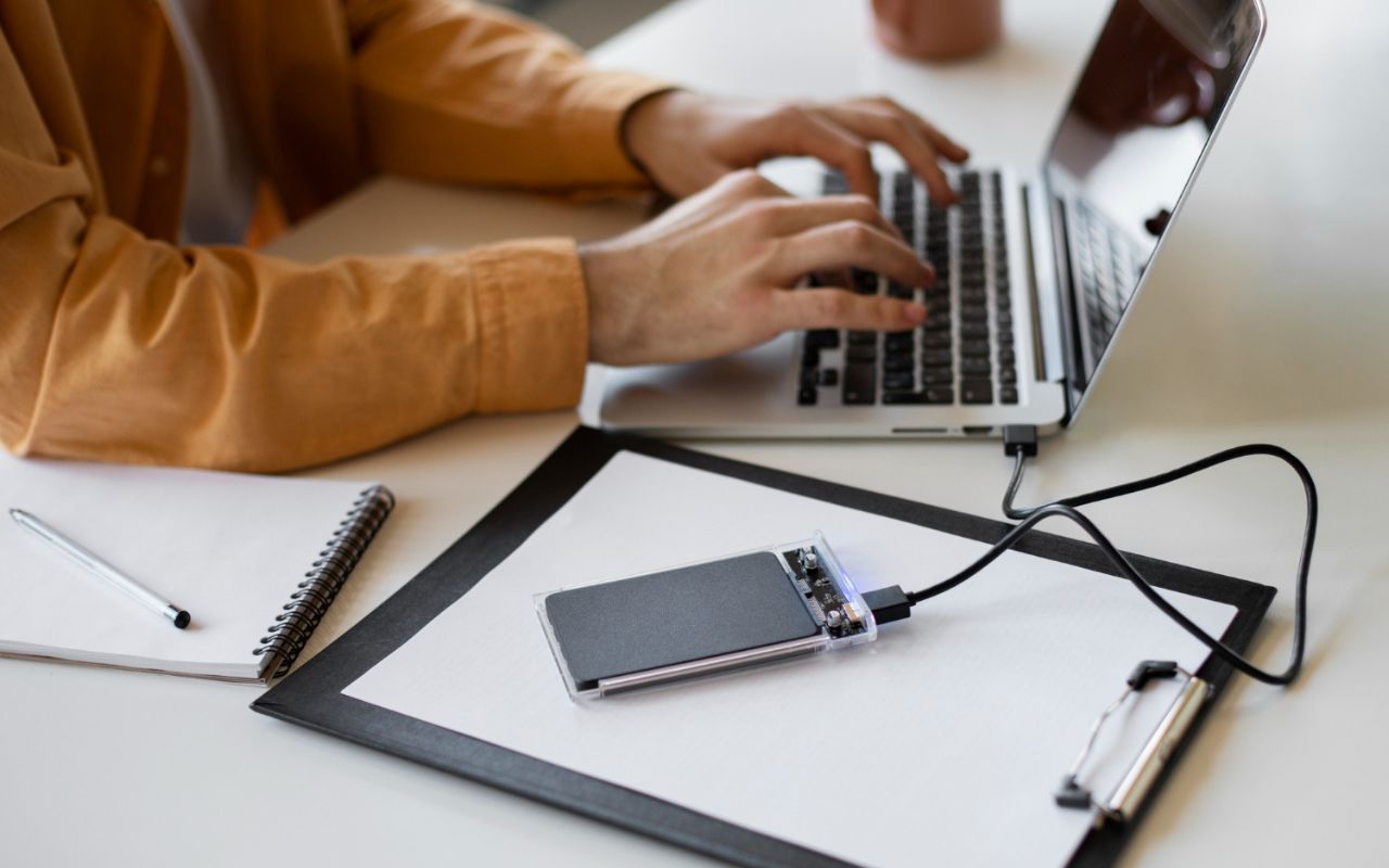 User backing up important Windows 11 files to external hard drive and cloud storage.