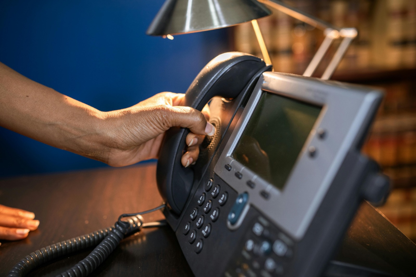 Hand reaching for a ringing rotary phone with a coded ring pattern