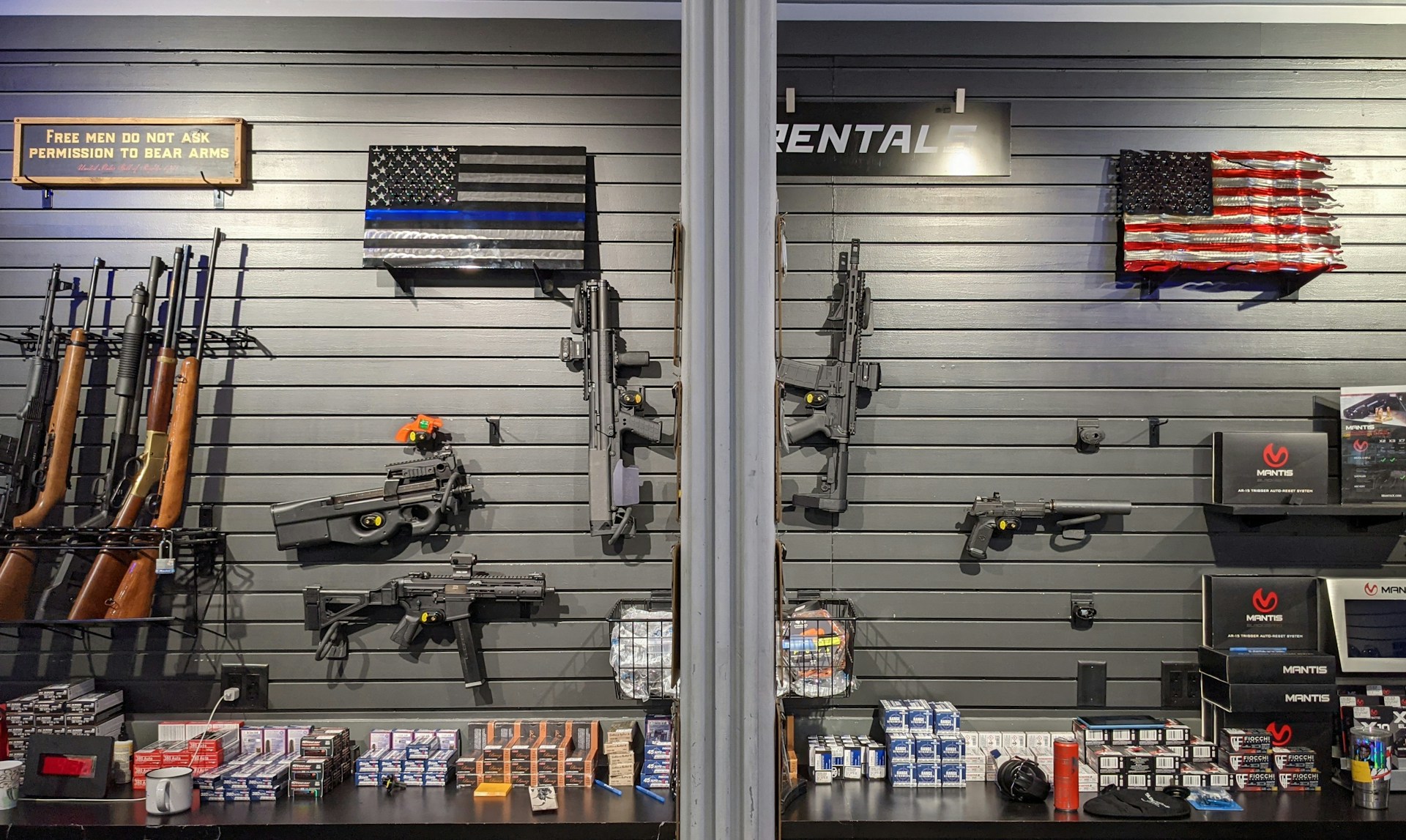 gun show with vendors and buyers examining firearms at display tables