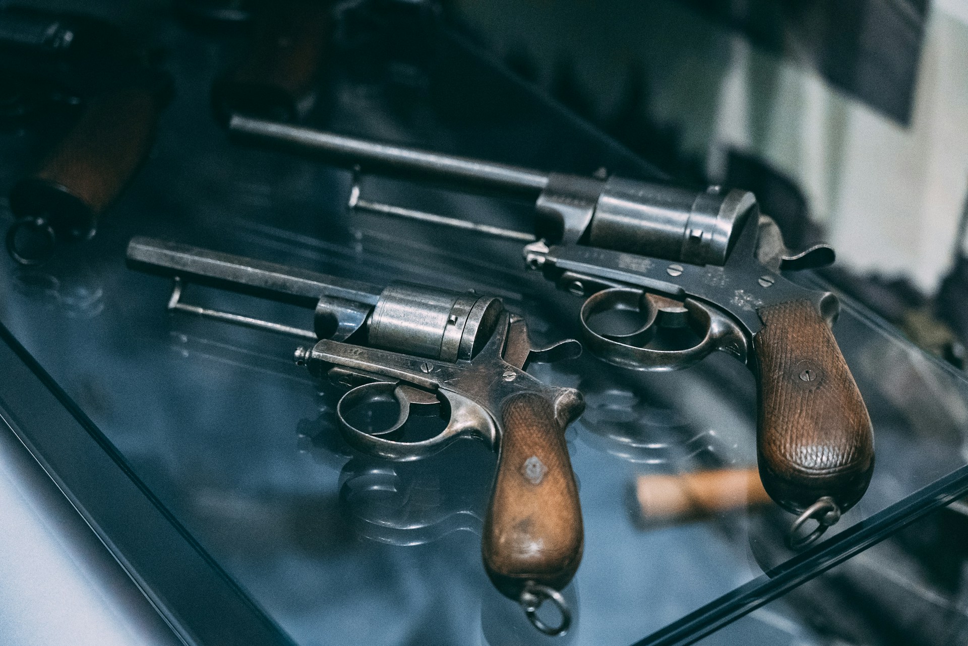Vintage firearm displayed in glass case with rare label at gun show
