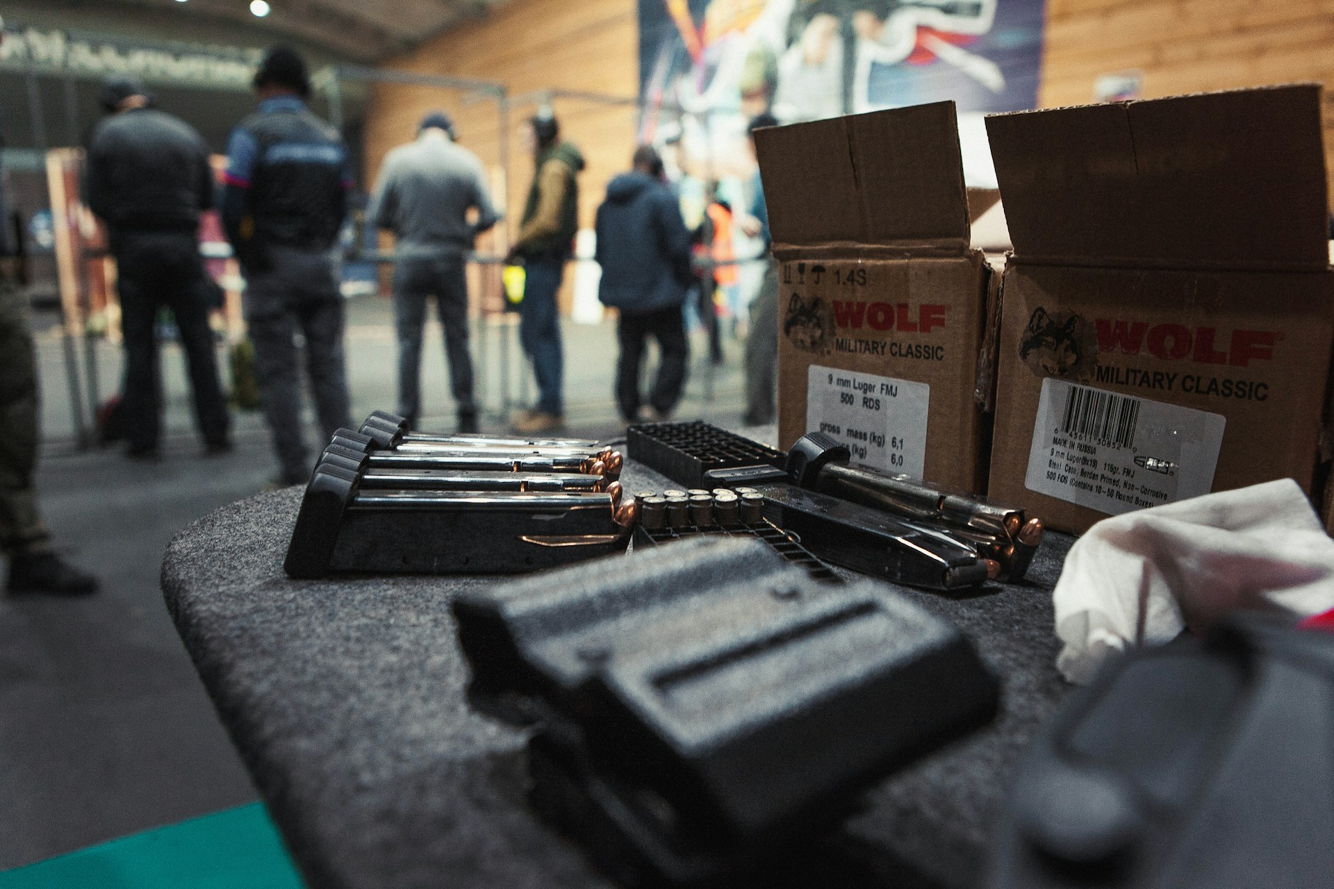 Gun show seller talking to buyer examining firearm