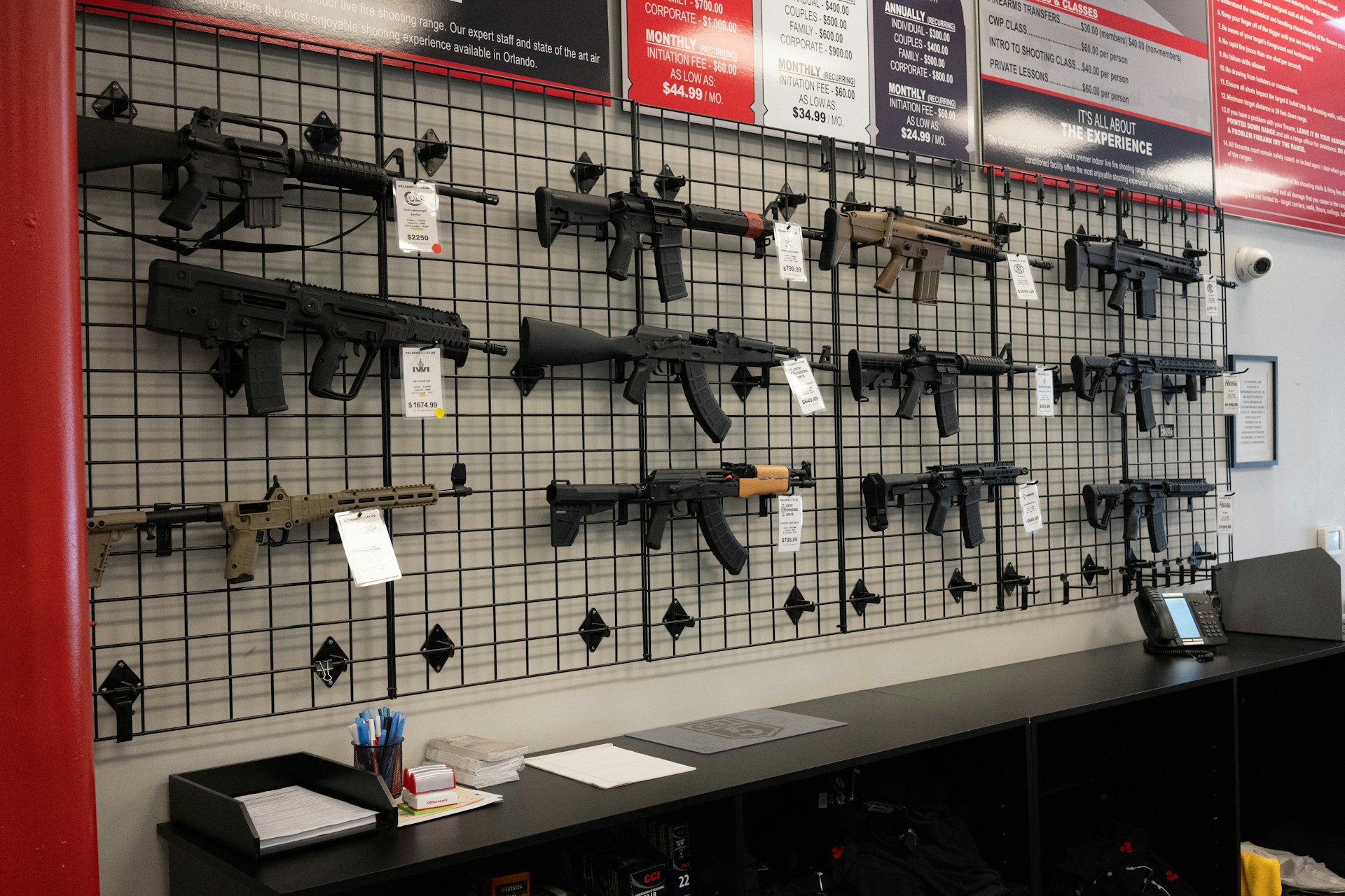 Gun show aisle with multiple vendors and price tags displayed