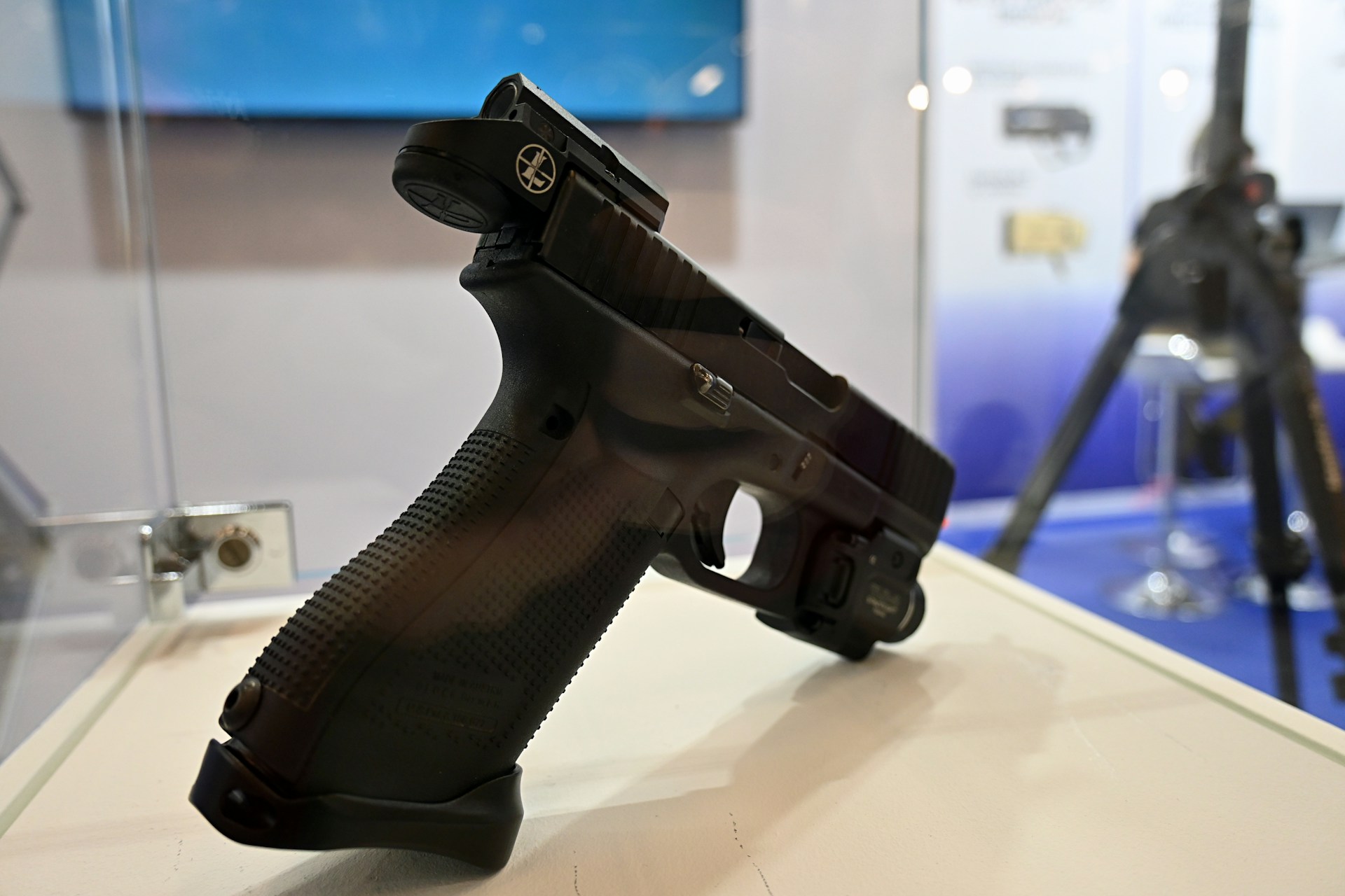 inspecting a used handgun at a gun show table