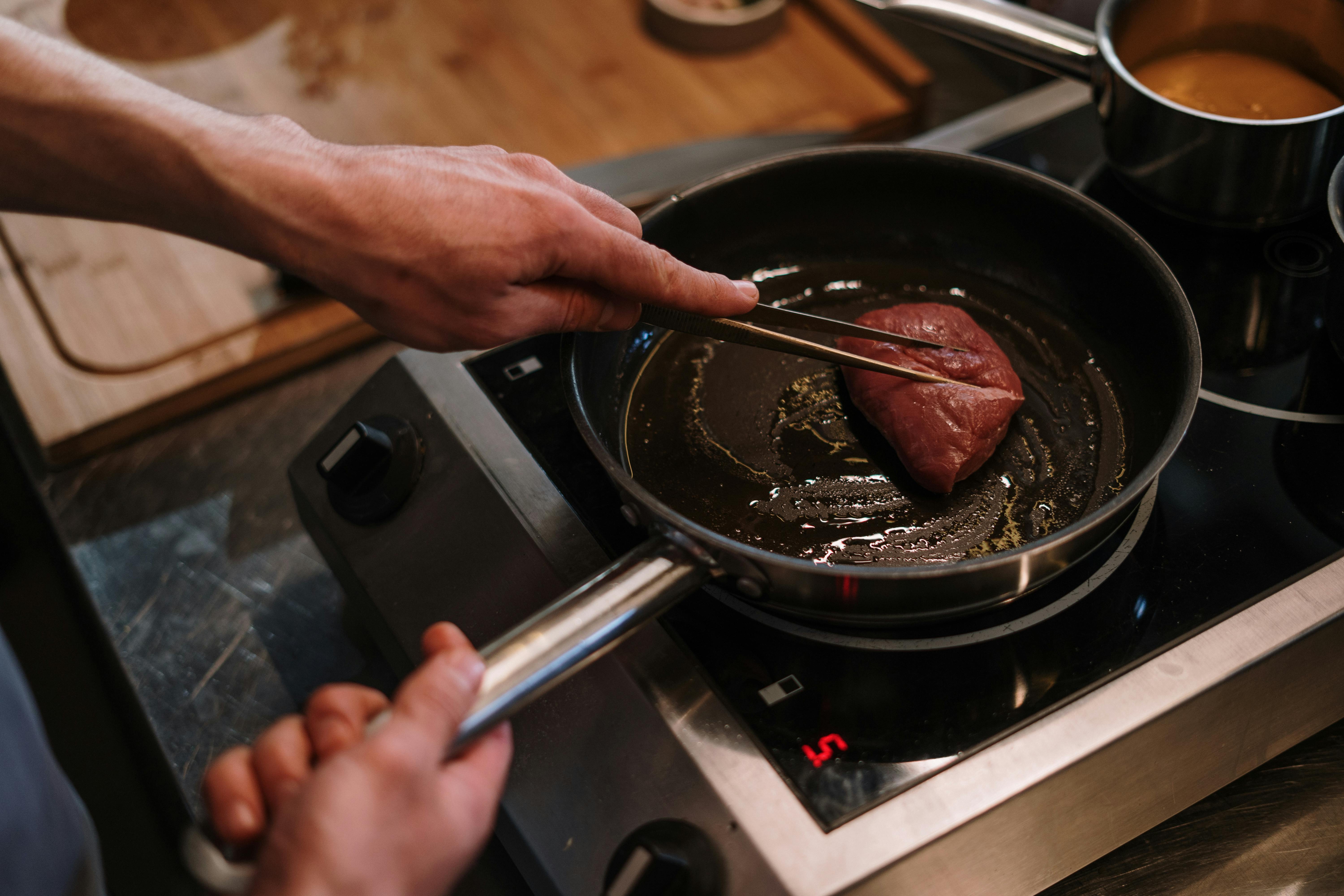 Raw steak left out on countertop too long, showing risk of uneven cooking and safety concerns.