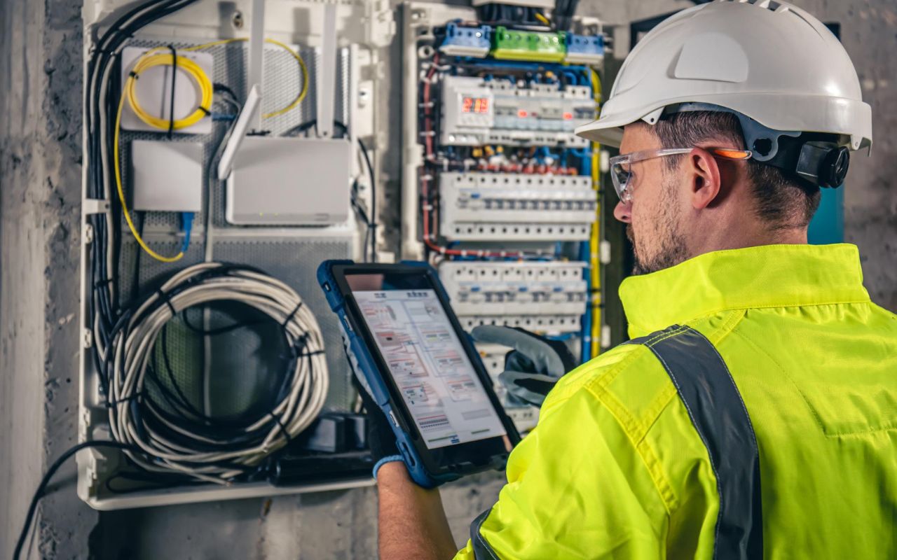 Inspector checks electrical permits and local code compliance during a home renovation.