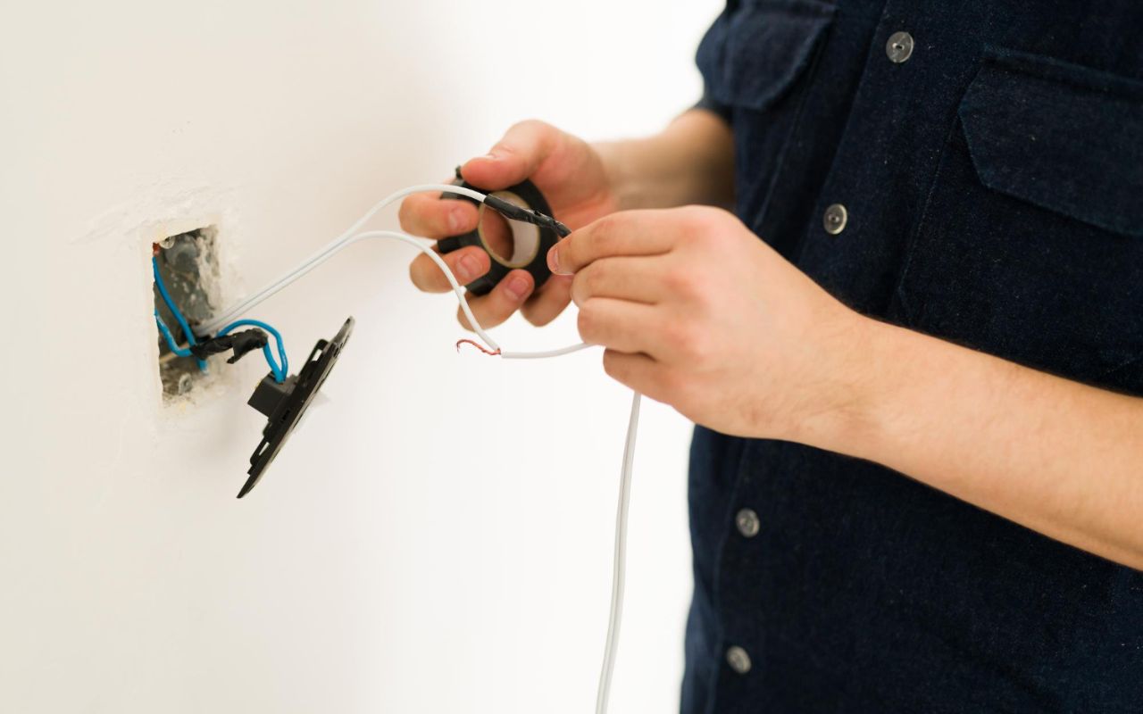 Comparing copper wires to a wire gauge chart to ensure correct amperage for safety.
