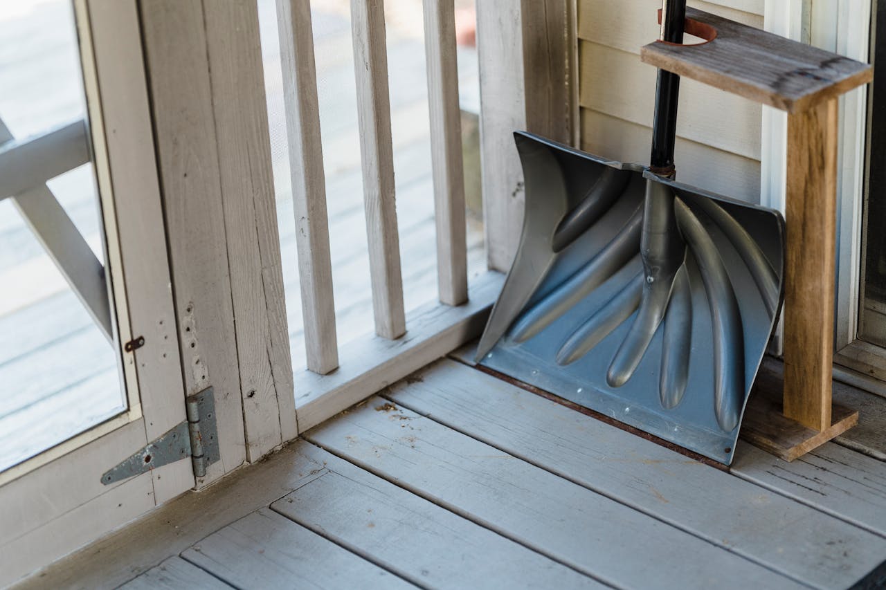Shovel resting in an unheated garage or porch