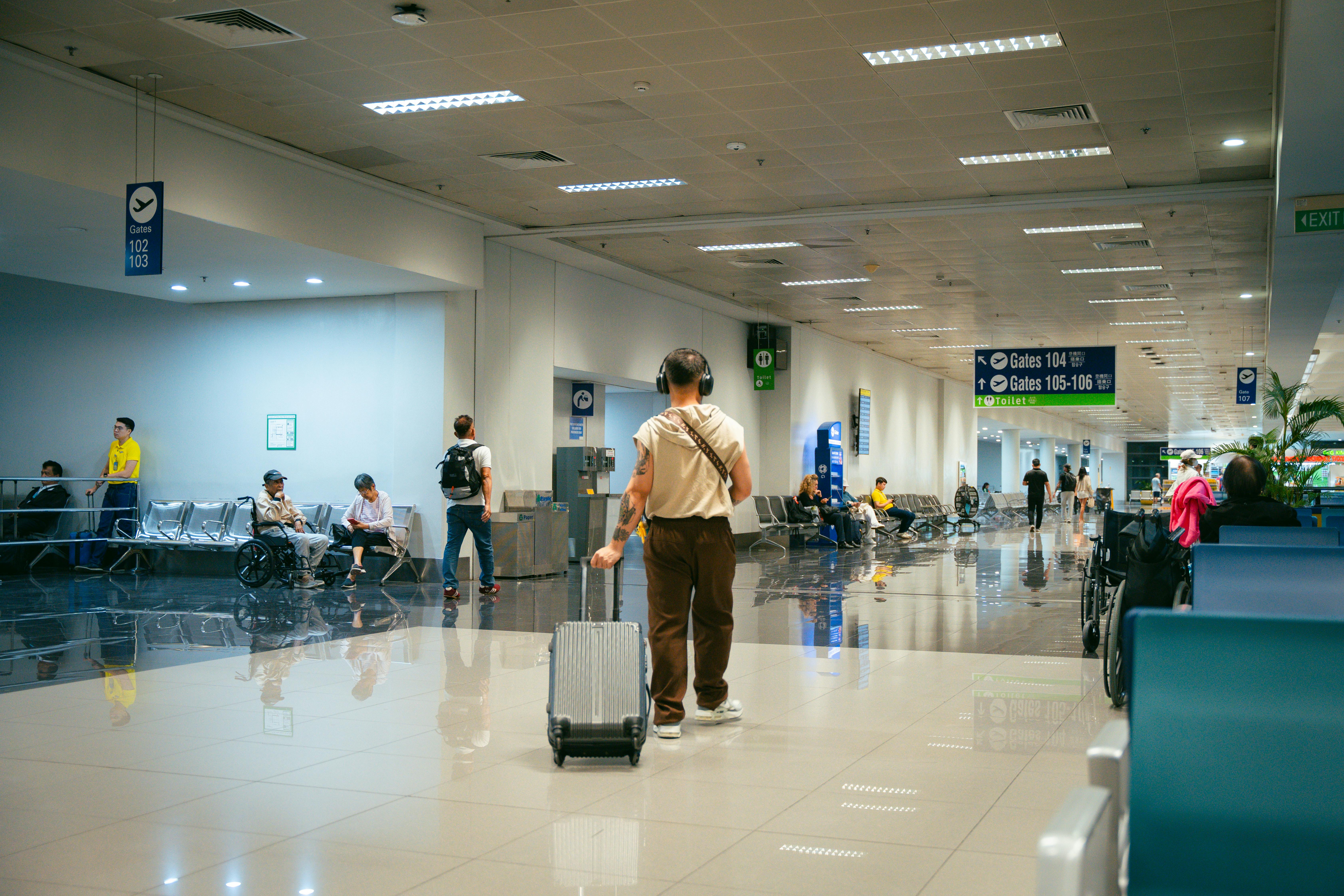 Passengers waiting to board while airline staff organize priority boarding