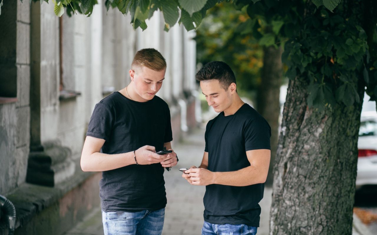American tourist looking at a smartphone while visiting a European landmark
